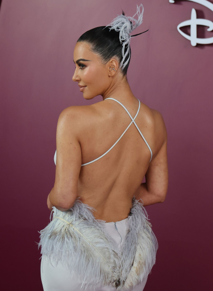Kim Kardashian with her back to the camera wearing a feather updo